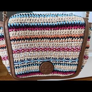 Tory Burch straw and multicolor leather handbag with gold chain accent detail.